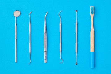 Dentist tools over blue background top view