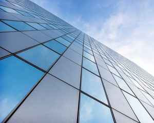 Fototapeta na wymiar glass facades of modern office buildings and reflection of blue sky