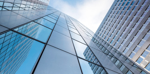 glass facades of modern office buildings and reflection of blue sky