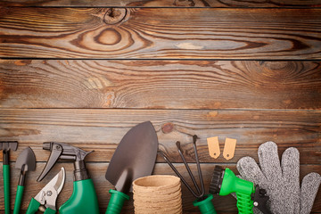 Gardening tools on wooden background flat lay