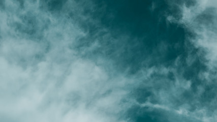 Naklejka na ściany i meble Abstract background in the form of sky and irregular clouds the dominant color aqua menthe. A rough background for all inspirational designs.