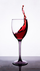 Splashes of red wine in a glass
