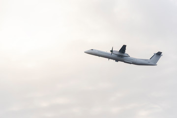 Passengers airplane flying in the sky. White aircraft in the air
