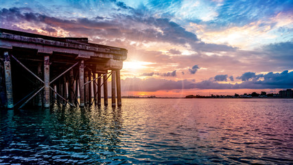 Sunrise over the Mississippi River alongside a pier in New Orleans, French Quarter, Louisiana, USA.