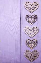 wood lasercut hearts on a lilac wood background