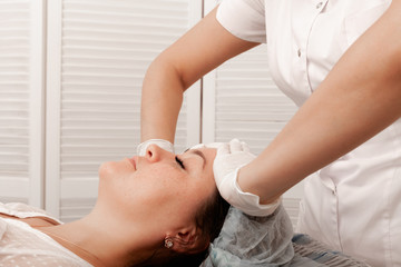 Fototapeta na wymiar Face massage. Facial beauty treatment.Cosmetology.