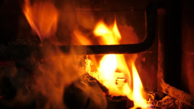 Fire buring in Fireplace. Real time. Close-up.