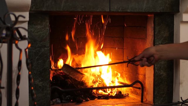 Old person using fireside iron tool set. Fireplace tools sets in the attic. Isoltated closeup.