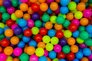 Fototapeta na wymiar Plastic multi-colored balls for a dry pool. A lot of bright colors. Kids toys. place for text.
