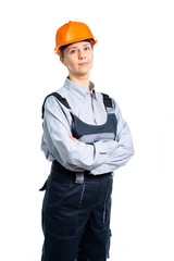 pretty cute builder girl in uniform and helmet . Isolated