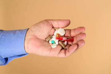 Different pills prescribed by doctor. Medicine, treatments and healthcare. Medicine pills in hand. Tablets in hand of patient. Medical concept. Hand of man holds different pills. Man hands with pills.