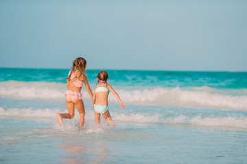 Kids have a lot of fun at tropical beach playing together