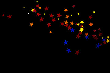 a scattering of blue, red, orange and yellow sequins in the shape of stars, isolate on a black background