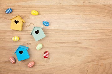 Easter decoration over natural wooden backgraund. Top view, flat lay. Minimal creative greeting card, invitation concept