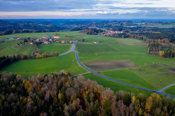 Aerial view Autumn landscape in Bavaria near Miesbach. top view of the field and autumn forest