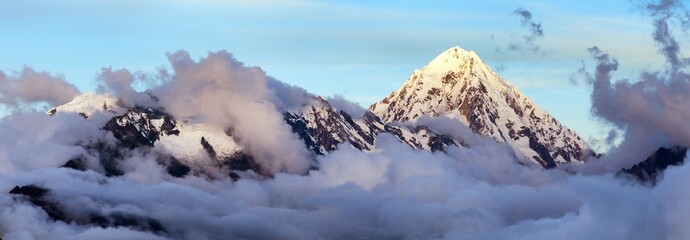 Evening view of Mount Salkantay in the middle of clouds - obrazy, fototapety, plakaty
