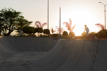 backlighting skateboard rink at sunset.