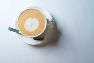 Cup of fresh coffee with heart sign