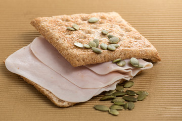 sandwich of ham and whole wheat bread with pipes