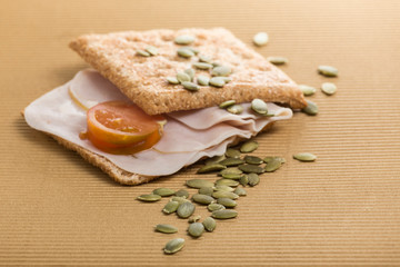 sandwich of ham and whole wheat bread with pipes