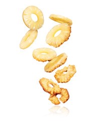 Pineapple rings turn into dry rings in the air on a white background