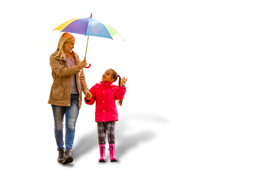 Happy young family using umbrella. Isolated on white mother daughter