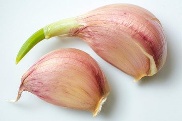 Isolated clove of garlic on a white background.
