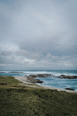the green field behind the Atlantic Ocean