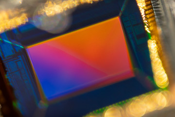 Small Digital smartphone camera CMOS Sensor macro shot with rainbow reflection