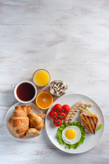 Fried eggs, sausages and vegetables on plate