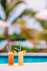 Fototapeta na wymiar Two tasty cocktails on tropical white beach