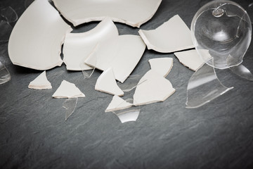 Broken Plate or broken water glass on the on the floor in the kitchen The concept of accidents in...