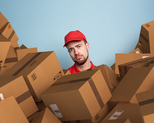 Courier is confused due to a lot of packages to deliver. concept of overwork and growth internet...