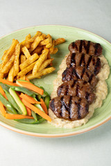 Grilled minced meat stakes served with french-fries and sauce