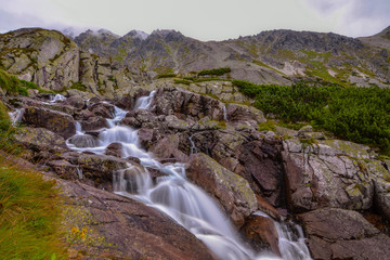 Fototapeta na wymiar between the rocks of the mountain stream below the ridge