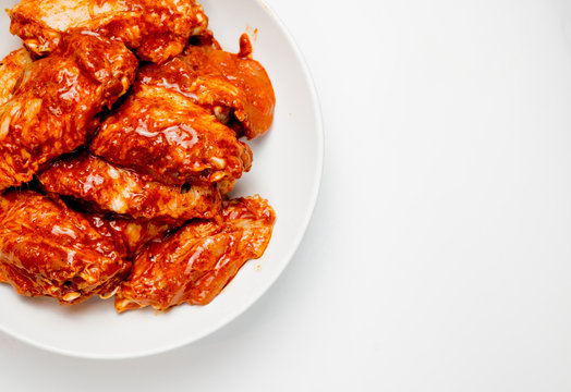 Marinated Chicken Wings In A Plate On A White Background