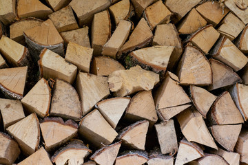 The training of farmers for winter. The wood is stacked in a woodpile. Background