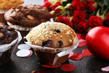 chocolate muffins, blueberry muffin and nut muffins on dark background for Valentine's day. tinting. selective focus