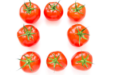 Group of delicious ripe red tomatoes lie in rows on white background. Top view. Healthy and organic food concept. 