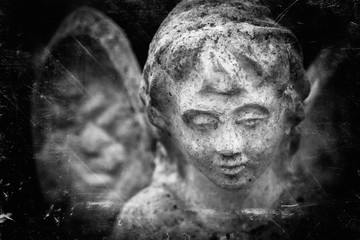 Close up antique statue of angel. Retro filter and vintage style.