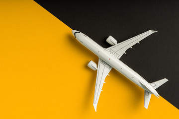 Plane on yellow and black background. Travel and aero space industry concept, booking summer...