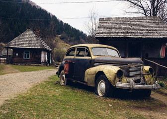  Vintage car in an abandoned forest village in the mountains