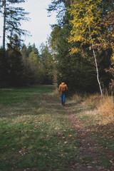 man running in autumn forest