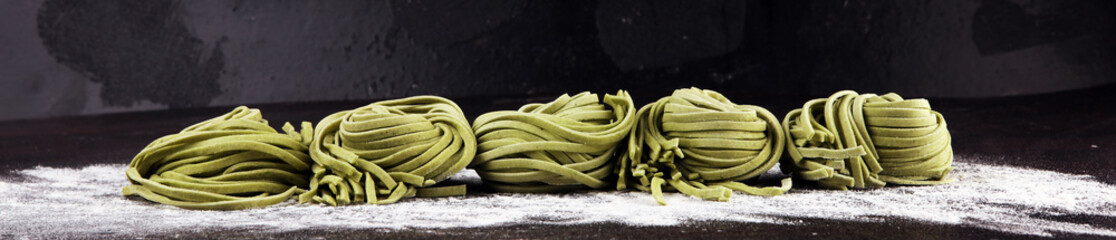 Closeup of raw homemade pasta tagliatelle. fresh italian traditional raw fresh green organic pasta