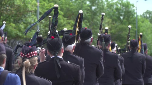 Bagpipers in Scotland playing the pipes in a Parade. Scottish culture