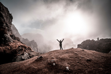 A young girl in the cloudy sunrise at the top of the mountain of Aiako Harriak, Oiartzun. Basque Country