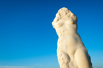 Ancient unfinished headless nude female bust of Ariadne, the mythological Greek princess, in textured white Mediterranean marble on the island of Naxos, Greece