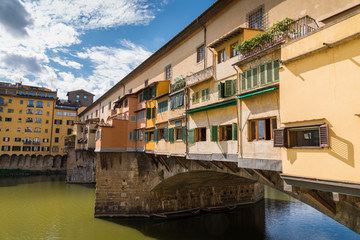 Ponte Vecchio in historical center downtown in Florence during a sunny day with historical old buildings