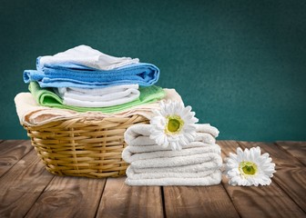 Laundry Basket with colorful towels on wooden desk