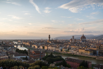 Obraz premium Florence romantic panoramic view from above during a coloured sunset on buildings Duomo churches and Ponte Vecchio